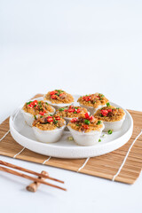 kue talam ebi or kiam kue made from rice flour, coconut milk with toppin dried shrimp, fried onion, chili slice and onion leaf. selective focus