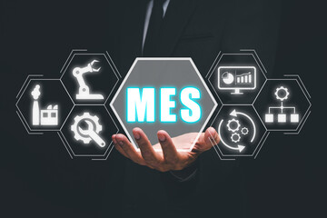 MES - Manufacturing Execution System concept, Businessman hand holding Manufacturing Execution...