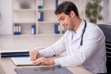 Young male doctor in telemedicine concept