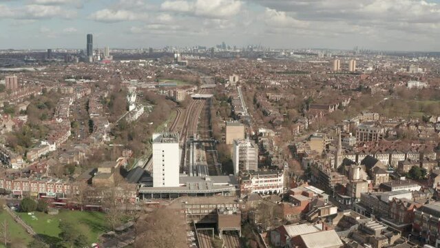 Aerial shot of Elizabeth Line train leaving Ealing Broadway for central London