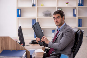 Young male employee working in the office