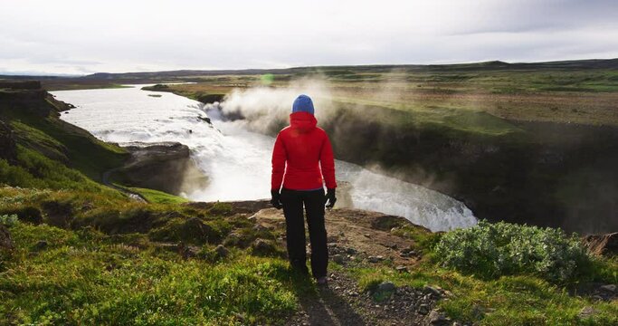 Iceland. Waterfall Gullfoss on Iceland in Icelandic nature. Tourist looking at Gullfoss aka Golden Falls is a famous tourist attraction and landmark destination on the Golden Circle, Iceland