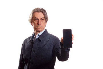 An elderly man demonstrates the screen of his phone, holding it forward in his hand. - 588195169