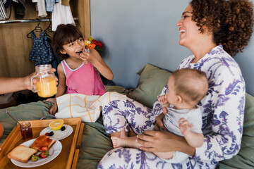 latin family having breakfast on bed at home in Mexico Latin America, hispanic people