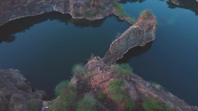 Aerial Drone shot of Abandoned quarry Lake formed by a stone mine  during evening in India