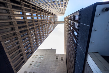 looking up at skyscrapers during a sunny afternoon with clear skies in Atlanta. the city...