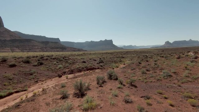 FPV drone explores a sunny summer day in the valley at Indian Creek, Utah - Powered by Adobe