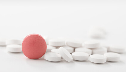 Red and white pills on white background. Heap of assorted various medicine tablets and pills.