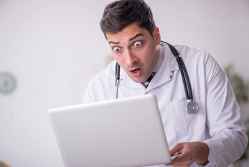 Young male doctor in telemedicine concept
