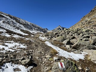 Hiking trails or mountaineering routes in the autumn Swiss Alpine environment of the Albula Alps and above the mountain road pass Fluela (Fl&uuml;elapass), Zernez - Canton of Grisons, Switzerland (Schweiz)