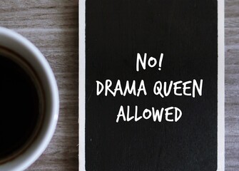 Coffee and chalk board written NO DRAMA QUEEN ALLOWED , to avoid those who gets too upset or angry over small problems, overreact to situations in dramatic or exaggerated way