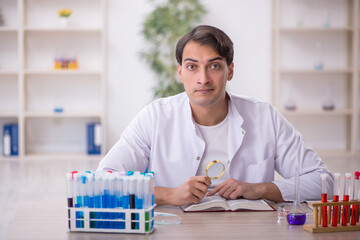 Young male chemist working at the lab