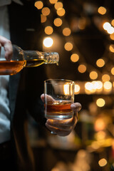 Businessman sitting and holding glass of whiskey