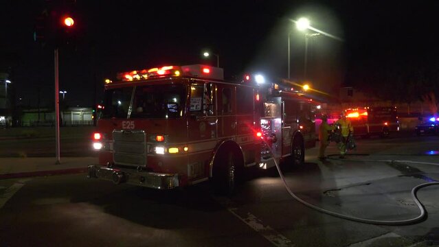 fire truck parked with flashing lights and sirens- establishing
