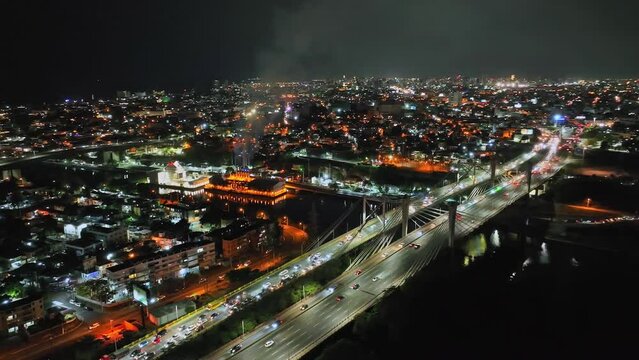 Juan Bosch and Juan Pablo Duarte bridges at night, Santo Domingo in Dominican Republic. Aerial drone panoramic view