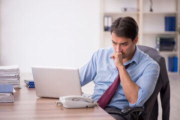 Young male employee working in the office