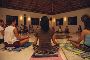 many people in lotus position in a meditation ceremony