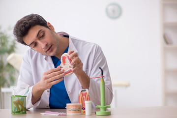 Young male dentist working in the clinic