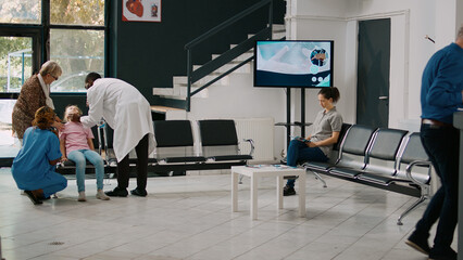 Elderly people taking sick niece to emergency checkup, feeling dizzy and light headed. Young child...