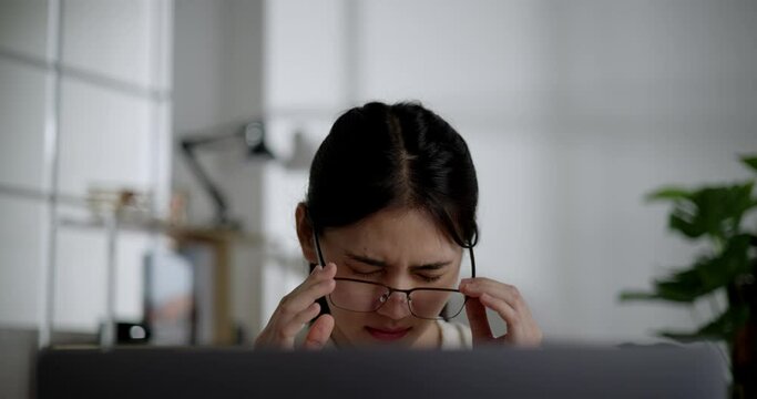 Handheld shot, Tired young woman worker in eyeglasses online work, Female employee overworked feeling eye strain after using laptop computer working from home