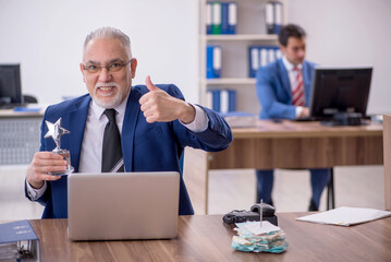 Two male colleagues in employee of the month concept