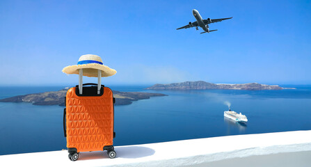 Banner of travel concept with Orange luggage and hat as landscape view of Oia town in Santorini...
