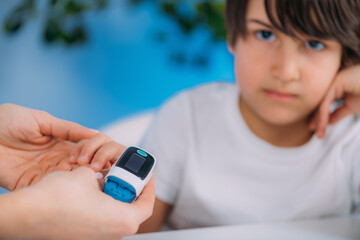 Pulmonology pediatrician measuring blood oxygen levels with pulse oximeter