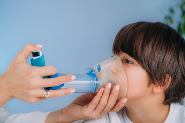 Pulmonologist Helping Little Boy with Aero chamber.