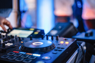 Fototapeta na wymiar DJ Spinning. mixing and scratching in a night club. DJ playing music at mixer. Closeup. Party.