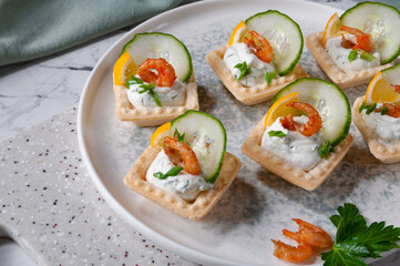 Tartlets with stuffing lying on a stone board.