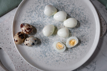 Fototapeta na wymiar Boiled eggs lying on a plate, on a board. Useful and tasty ingredient.