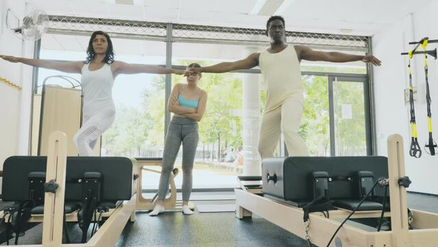 Active woman and man who care about their health training with instructor. High quality 4k footage