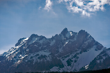 Fototapeta premium Scenic landscape and Swiss Alps with mount Pilatus seen from City of Emmen, Canton Lucerne, on a sunny spring day. Photo taken March 22nd, 2023, Emmen, Switzerland.