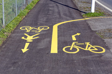 Obraz premium Yellow rad markings at combined footpath and bicycle lane at City of Emmen, Canton Luzern, on a sunny spring day. Photo taken March 22nd, 2023, Emmen, Switzerland.