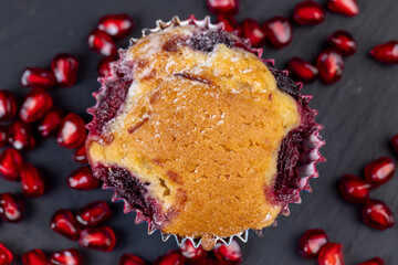 Wheat fresh cupcake with cherry and red pomegranate