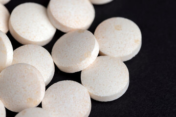 White and yellow medical medicines on a black background
