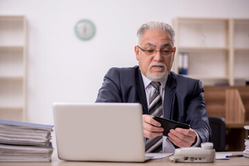 Old male boss employee working in the office