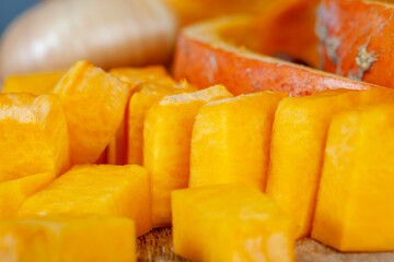 Sweet ripe orange pumpkin is sliced on the table
