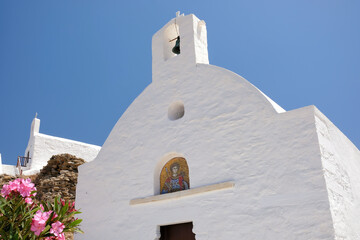 View of two small whitewashed churches at the top of the hill in Ios Greece