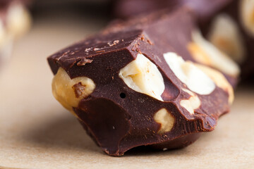 Pieces of homemade milk chocolate with lots of hazelnuts