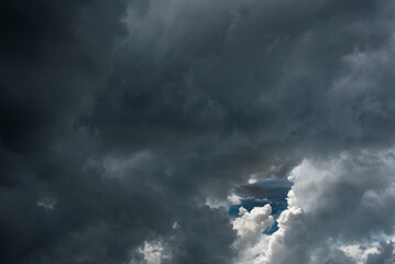 Dark thunderstorm clouds rainny landscape. Meteorology danger windstorm disaster climate. Dramatic dark storm thundercloud rain clouds on black sky background.Dark cloudscape storm disaster gray sky