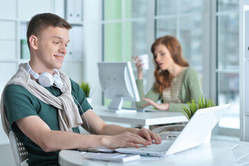 young man and woman working in office