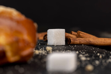 Refined sugar pieces on a black slate board
