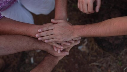 Unrecognizable people hands put palms on each other above under the ground. Group of people community and friendship