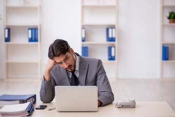 Young male employee working in the office