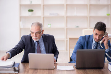 Two male employees working in the office