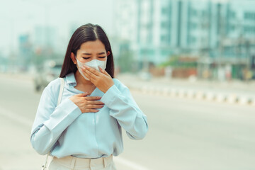 Fototapeta premium Asian Women wearing Protection Mask feels headaches and cough due to air pollution PM 2.5 Air pollution caused health problems. environmental pollution