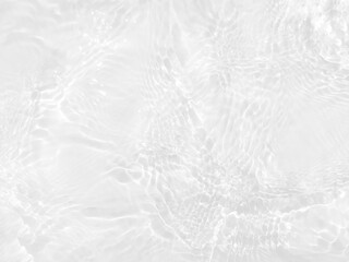 Defocus blurred transparent white colored clear calm water surface texture with splashes and bubbles. Trendy abstract nature background. Water waves in sunlight with copy space. White water shine