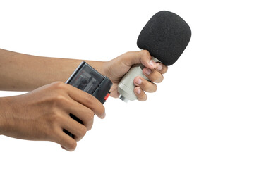 A human hand holding a microphone and recording device