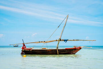 A wooden fishing boat with a traditional design, commonly found in Tanzania and located in the Indian Ocean near Zanzibar.